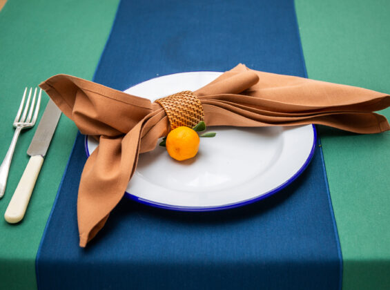 Cinnamon napkin on Oxford Blue table runner table cloth